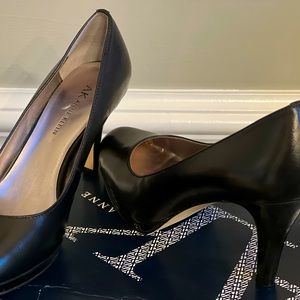 Black 7 1/2 Ann Klein pumps. Has a platform from toe to ball of foot.